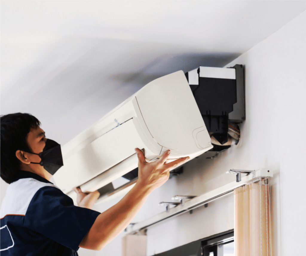 A technician working on AC Unit