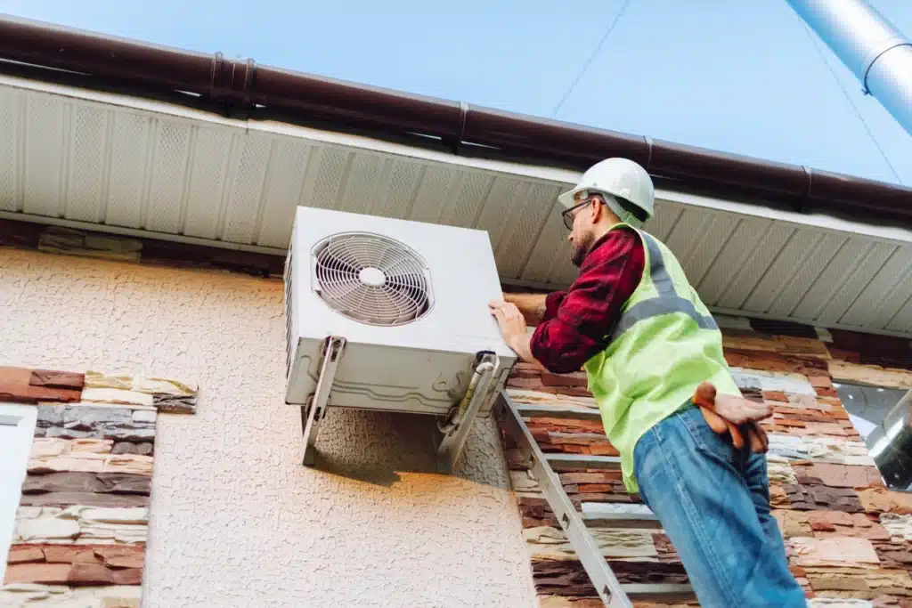 A technician is working on an air conditioner