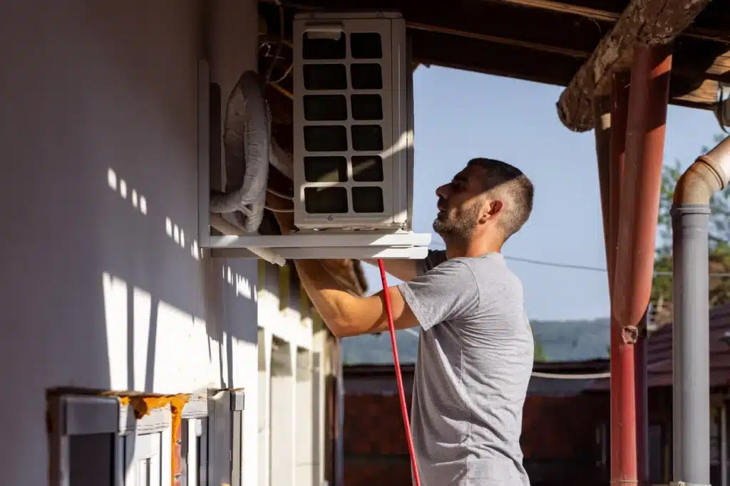 A technician is working on an air conditioner