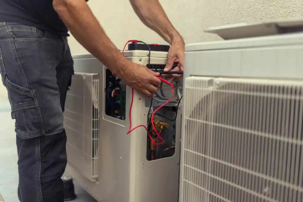 A technician is working on an air conditioner