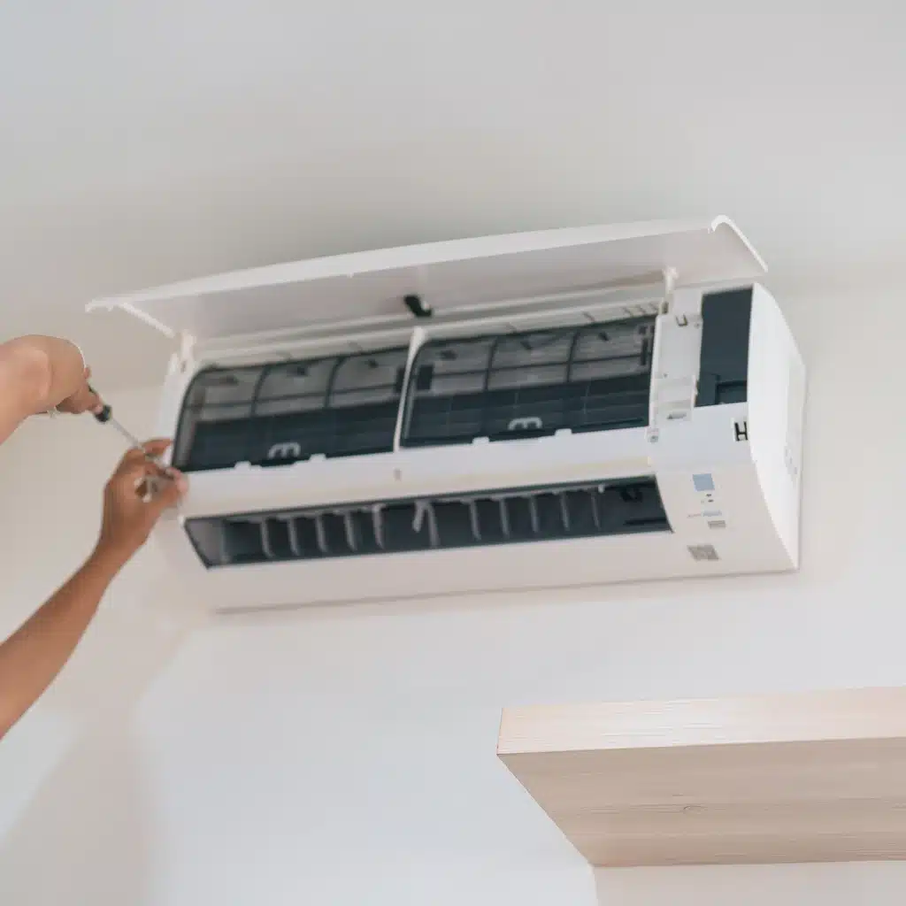 HVAC technician repairs an air conditioner in a room