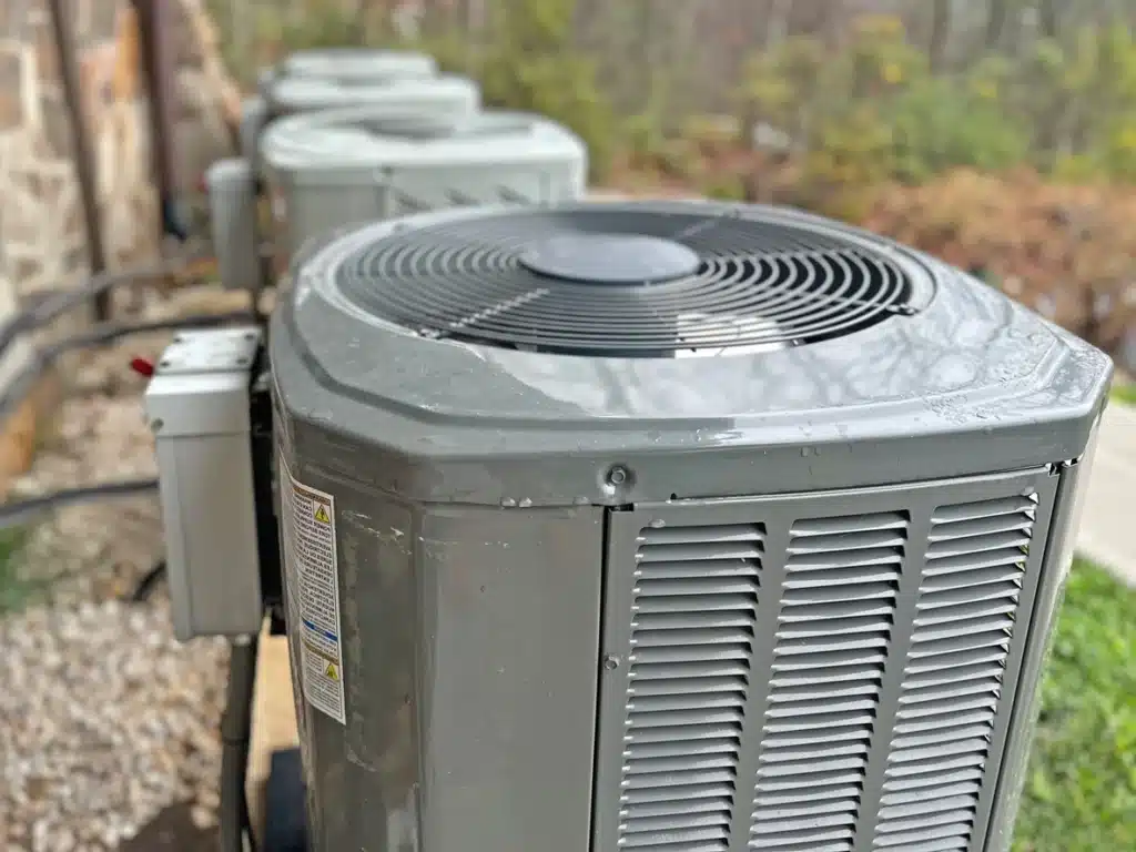 hree air conditioners arranged neatly on a wooden pallet